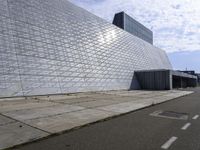 an image of the exterior of a building with white and grey colored tile on it