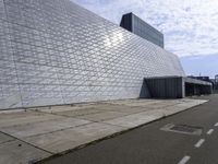 an image of the exterior of a building with white and grey colored tile on it