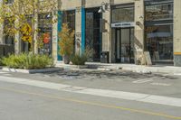 a bicycle is parked near a parking space in front of a building with art on the walls