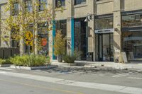 a bicycle is parked near a parking space in front of a building with art on the walls