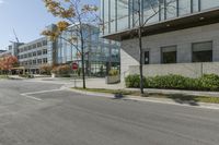 a traffic light on a road in front of buildings and trees in the background that have just been changed