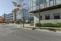 a traffic light on a road in front of buildings and trees in the background that have just been changed