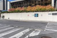 a road sign pointing to the right near a street with multiple parking spaces in the background