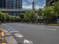 empty road with white lines on the streets of city area against cloudy blue sky on a sunny day