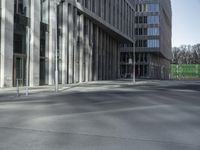 a view of a city street on a sunny day with a building in the background