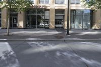 a sidewalk on the corner of an office building and storefront and sidewalk and sidewalk