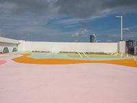 colorful concrete wall painted in the shape of a flower is in an outdoor area of a modern building