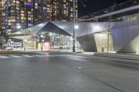 an urban street at night with modern buildings in the background by night time in the united states