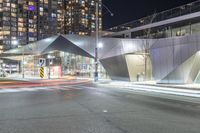 an urban street at night with modern buildings in the background by night time in the united states