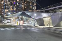 an urban street at night with modern buildings in the background by night time in the united states