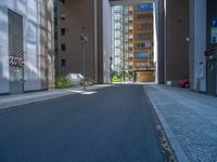 a road through which is a large modern building with an awning over it's entrance