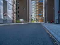 a road through which is a large modern building with an awning over it's entrance