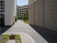 a wooden bench sitting in the middle of a courtyard area next to buildings in the background