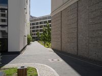 a wooden bench sitting in the middle of a courtyard area next to buildings in the background