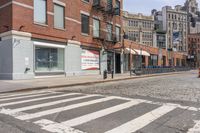 a crosswalk on the side of a road next to a street light and buildings