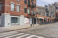 a crosswalk on the side of a road next to a street light and buildings