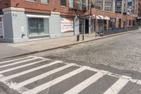 a crosswalk on the side of a road next to a street light and buildings