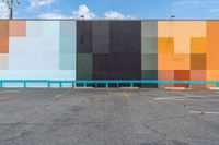 a colorful building painted in bright colors on the wall and concrete flooring around it