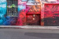 a fire hydrant on the side of a road with red graffiti painted all over it