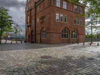 the clock tower in brick is built to look like a school building for boys and girls