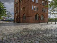 the clock tower in brick is built to look like a school building for boys and girls