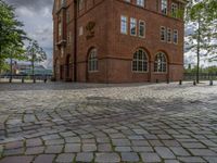 the clock tower in brick is built to look like a school building for boys and girls