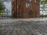 the clock tower in brick is built to look like a school building for boys and girls