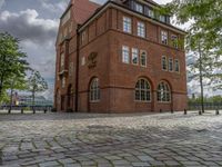 the clock tower in brick is built to look like a school building for boys and girls