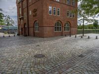 the clock tower in brick is built to look like a school building for boys and girls