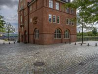 the clock tower in brick is built to look like a school building for boys and girls