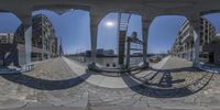 there is a large fisheye lens on the city street, showing all three colors of the same pattern