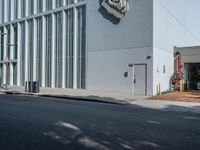 a white building with some windows on the side and a lion head statue on the outside