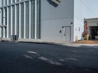 a white building with some windows on the side and a lion head statue on the outside