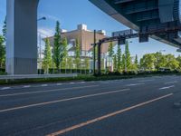 the city of richmond has long white arrows running down it's side and a pedestrian crossing over an expressway