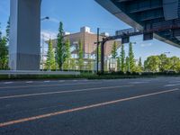 the city of richmond has long white arrows running down it's side and a pedestrian crossing over an expressway