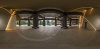 large circular mirror of office lobby with a desk in the center of it and stairs down to a hallway on the left