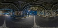 an upside down picture of a subway train track at night, taken from the rear window of a car