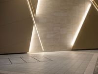 a hallway with columns on the wall that have led lights coming out of them and a door is behind the wall