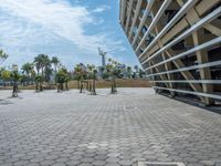 a wide view of a parking area with a skateboard in the distance and a building near it