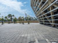 a wide view of a parking area with a skateboard in the distance and a building near it