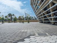 a wide view of a parking area with a skateboard in the distance and a building near it