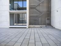 a view out of an entrance into the building with stairs and a stone floor below