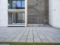 a view out of an entrance into the building with stairs and a stone floor below