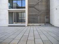 a view out of an entrance into the building with stairs and a stone floor below