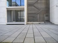 a view out of an entrance into the building with stairs and a stone floor below