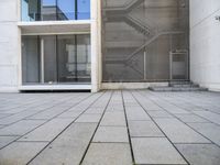 a view out of an entrance into the building with stairs and a stone floor below