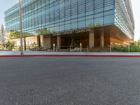 two grey blocks sitting next to a tall building on a sidewalk in front of grass