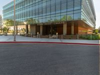 two grey blocks sitting next to a tall building on a sidewalk in front of grass