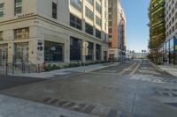 a photo of a street scene with buildings, cars and the sidewalk marked with lines