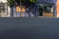 an empty city street with a sign that reads green on the sidewalk in front of a store